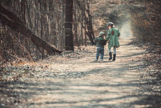 small children play in the woods, photo in vintage style