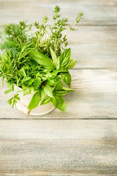 Fresh herbs outdoor on the wooden table