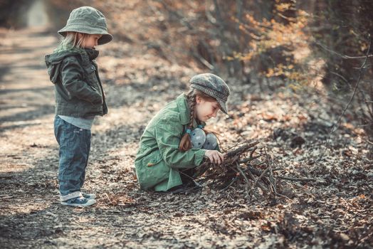 small children play in the woods, photo in vintage style