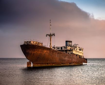 old broken ship agrounded near Lanzarote seashore, Canary Islands, Spain