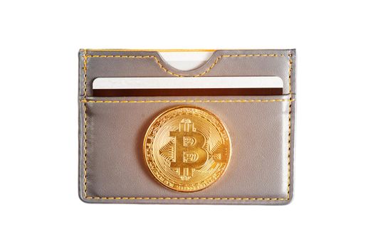 Symbol of virtual money - gold bitcoin on wallet with credit card on a white background.