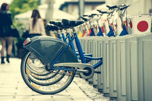 row of bicycles for city bike hire on a street