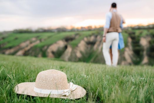 young couple a guy and a girl are walking in the green mountain hills