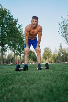 sporty man in park exercise crossfit workout. High quality photo