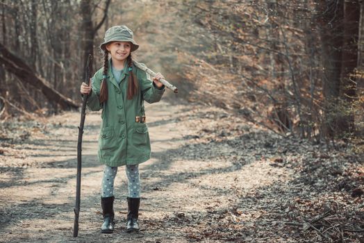 little girl goes through the woods with stuff, photo in vintage stylev