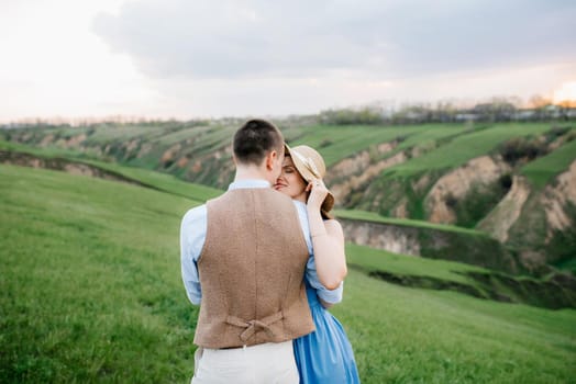 young couple a guy and a girl are walking in the green mountain hills