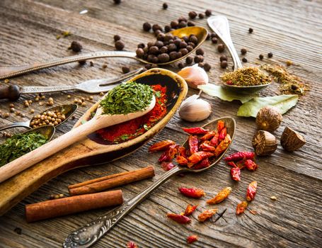 spices and herbs on a brown wooden table