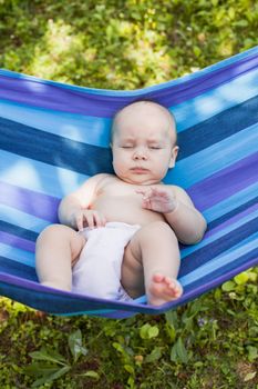 Baby in a hammock nave a daytime naps outdoors