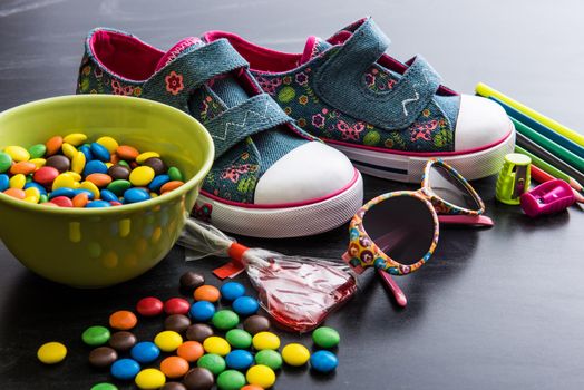 kid's stuff and sweets on a white background