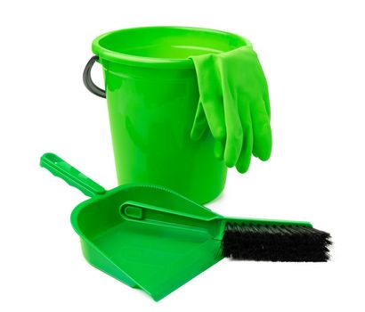 Green plastic bucket and a scoop isolated on white background, close up