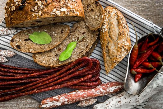 Wholemeal bread with dried sausages on a table