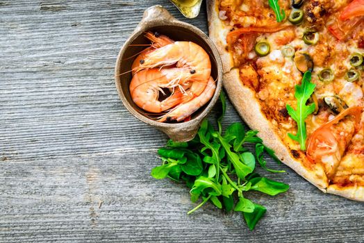 delicious pizza with seafood on wooden table