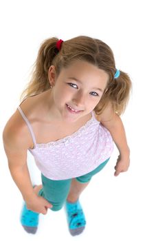 Preteen girl looking up at camera. Above view portrait of child posing in studio against white background. Cute girl wearing casual clothes