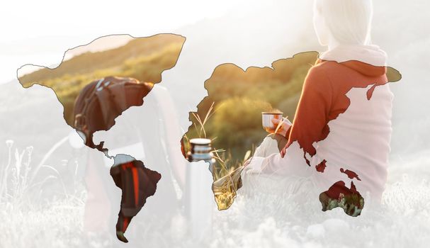 Double exposure of traveler woman with cup of hot tea or coffee outdoor with map of world.