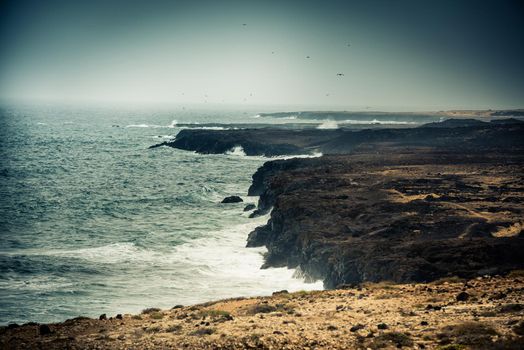 seawaves on a rocky shore at magnificent dusk