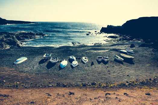 boats on a sandy stony tide