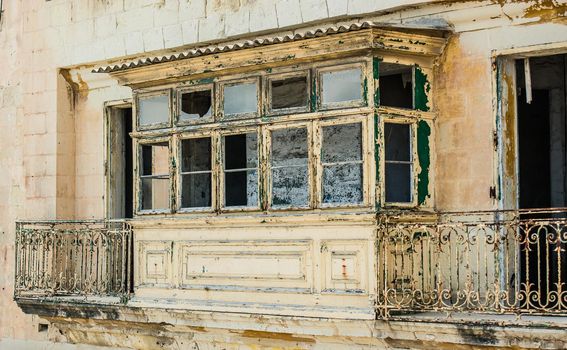 old ruined balcony in a street of historical center of Valletta in Malta