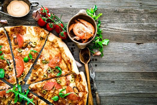 delicious pizza with seafood on wooden table