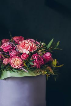 Still life with pink bouquet on the dark background.