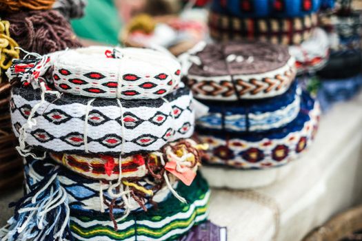 various colorful decorative knitted ribbons in hanks