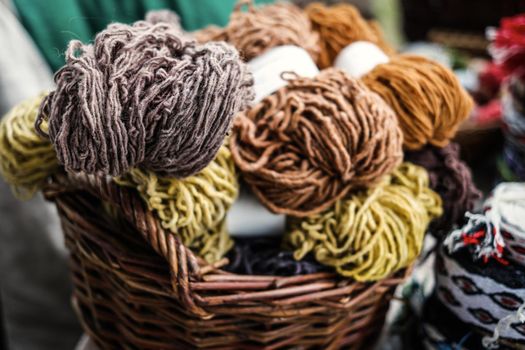 colorful woolen yarn in wooden baskets