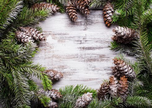 White shabby Christmas border with snow pinecones