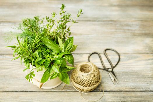 Fresh herbs outdoor on the wooden table. Preparation for drying