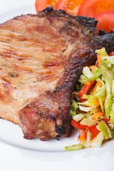 Grilled meat with spices on a white plate