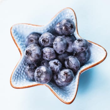 Blueberries close up in a blue bowl