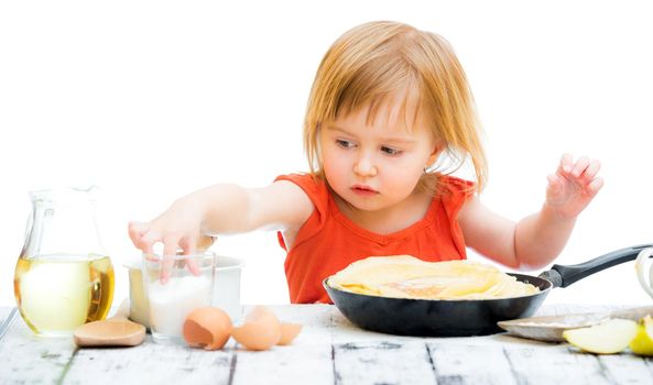 cute little baby girl with pancakes isolated on a white background