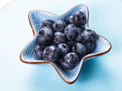 Blueberries close up in a blue bowl