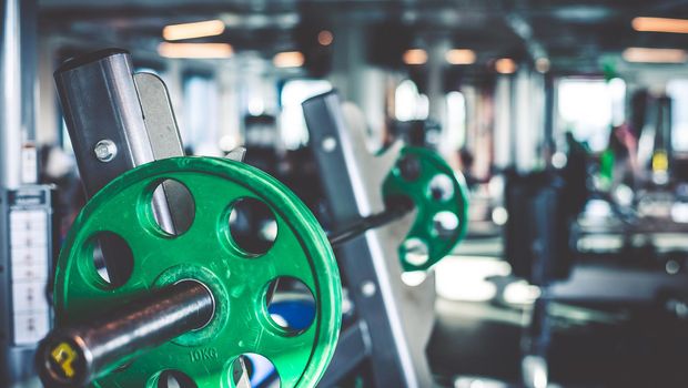 Rod with weights in the gym
