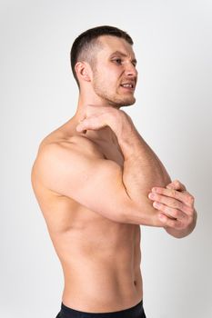 The elbow of the joint muscle in the male white background pain hurt injury, cramp sick male massage medical, expression. Hold red sickness, disease suffer attractive