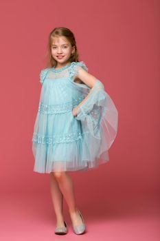 Beautiful little girl in an elegant dress in full growth. The concept of style and fashion. Layout for magazine cover. Isolated .