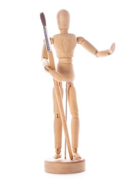 Art concept, wooden figure for modeling poses of human and paintbrush