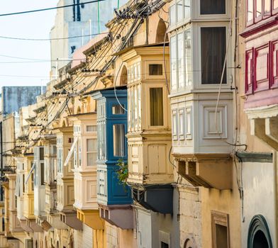 street with traditional balconies in historical center of Valletta in Malta