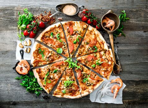 delicious pizza with seafood on wooden table