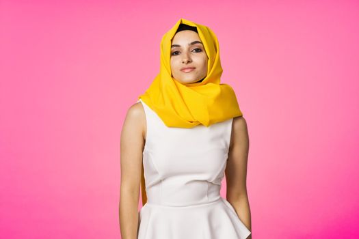 muslim woman in hijab posing fashion ethnicity pink background. High quality photo