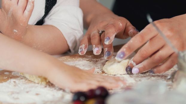 Woman's hands forming homemade pancakes from dough, close up