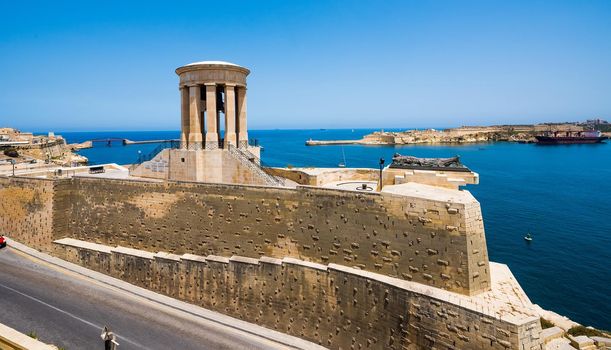 Siege Bell Memorial in Valletta on the sea background in Malta