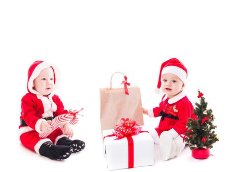 Santa baby girl and boy with gift box and christmas decorations on white
