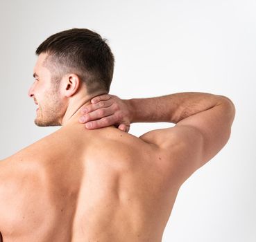 The muscles of the neck in a man on a white background are hurt pain body painful, cramp spine male massage adult, human expression. Touching lumbar care, problem suffer attractive