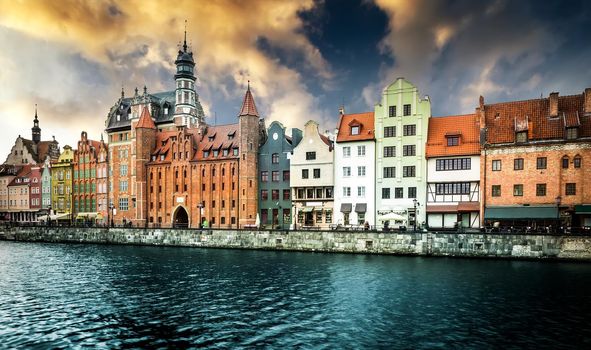 Cityscape on the Vistula River in historic city of Gdansk at sunset in Poland
