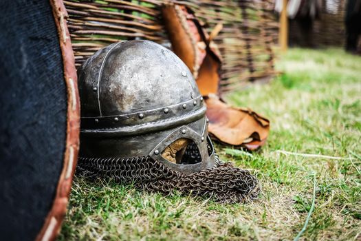 steel knight helmet with chain armour on grass