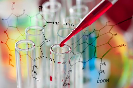 The blood from pipette over laboratory tubes