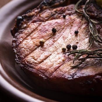 Meat steak roasted on grill with spices on the plate