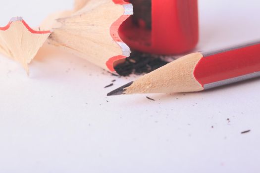 Pencil with red sharpener on white background isolated