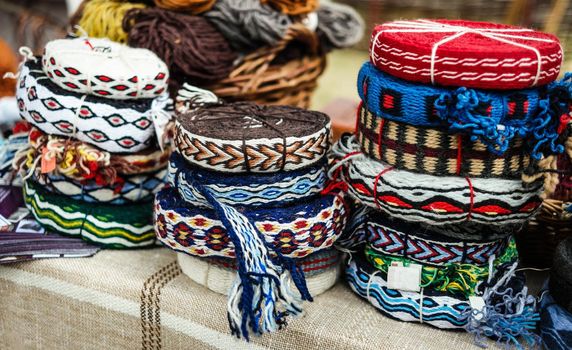 various colorful decorative knitted ribbons in hanks