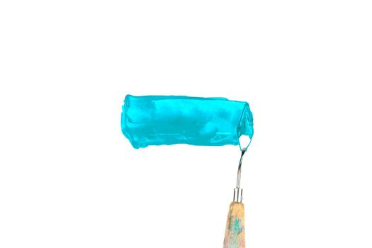 a painting palette knife isolated on a white background painting a blue teal with copy space.