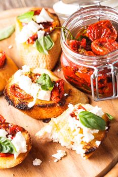 Bruschetta with olive oil, sundried tomatoes, feta and fresh basil